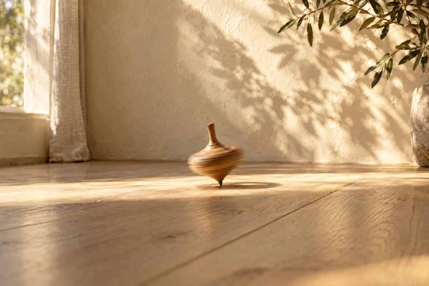 Wooden spinning top turning in one spot on sunlit oak floorboards, its outline softly blurred with motion